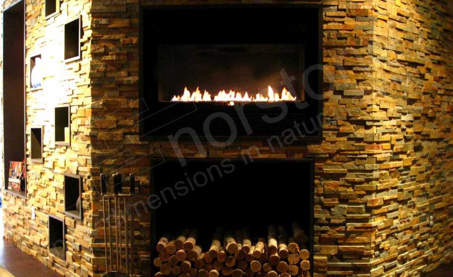 Stacked Stone veneer panels for fireplace used in a Basement on a fireplace and surrounding feature walls with cut logs