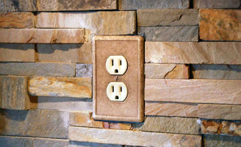 Stacked Natural Stone Veneer Rock Panels with an Outlet