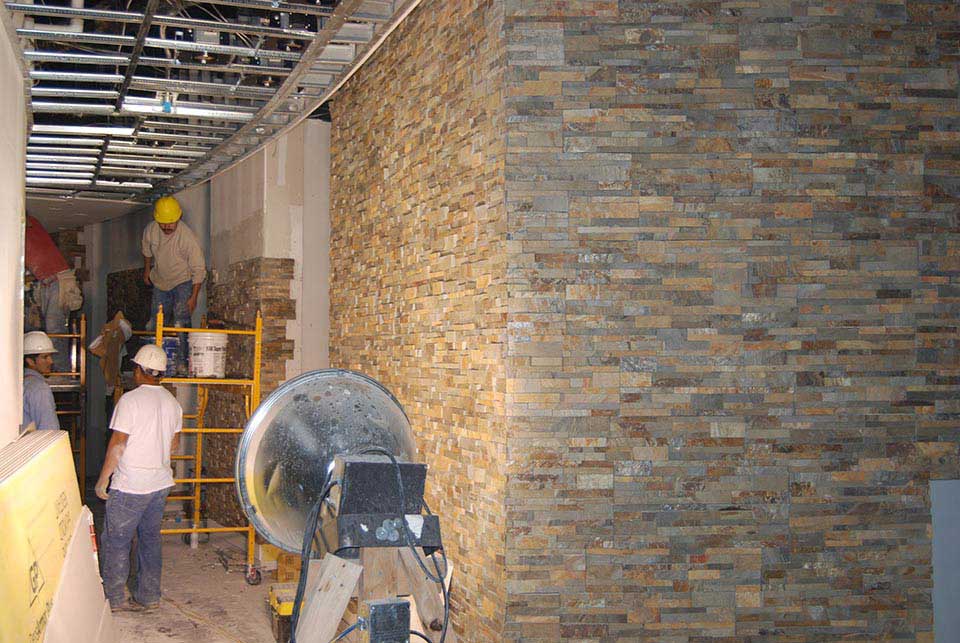 Commercial Installation Crew installing Norstone Stacked Stone Panel System in a corridor in Pompano Beach Florida Casino